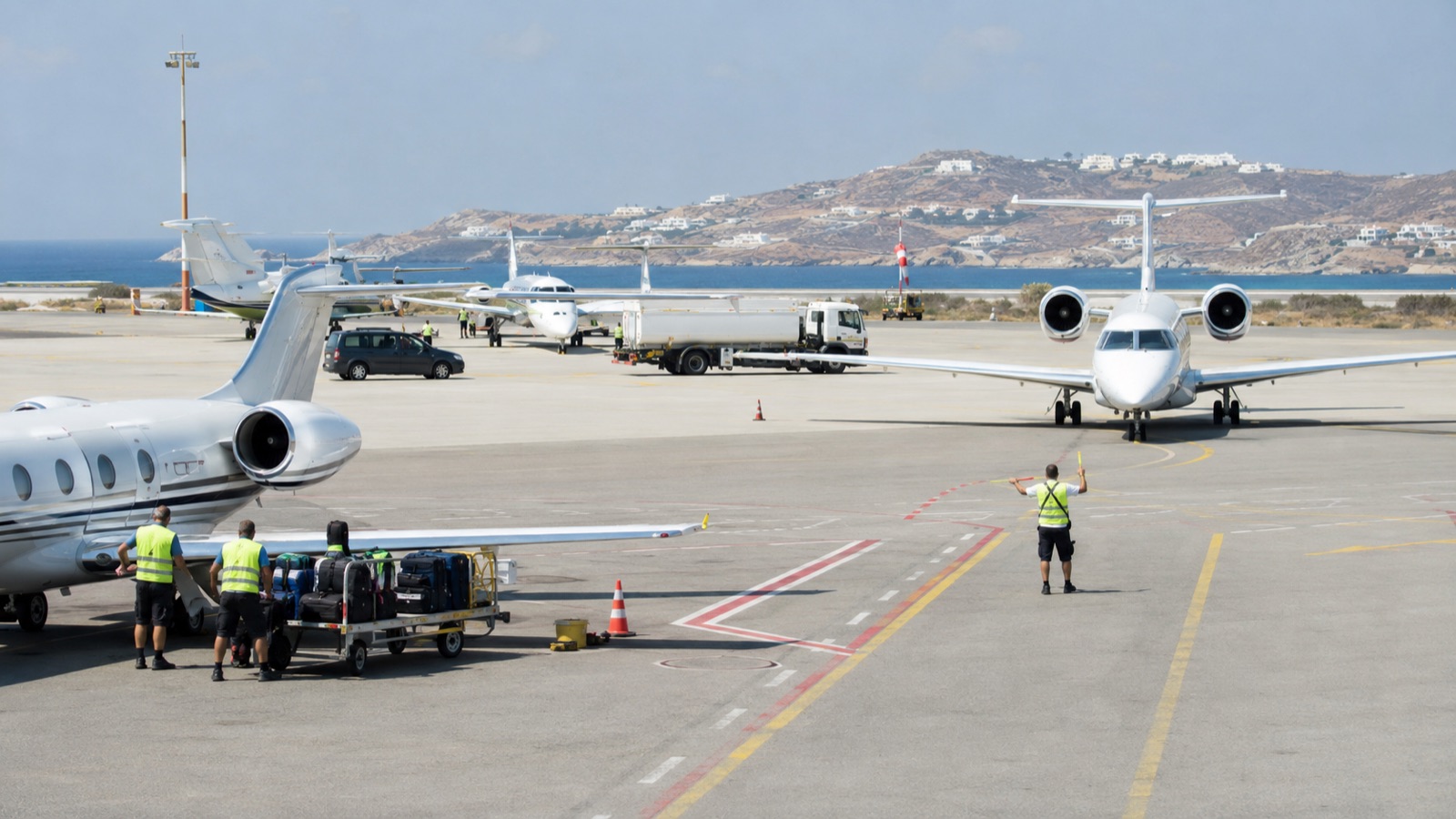 Private jet on a crowded Mediterranean island apron in summer